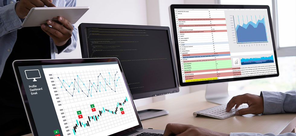 multiple-computer-screens-displaying-reports-and-analytics