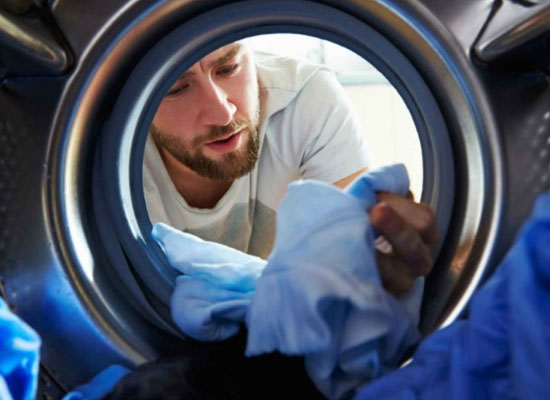 Man checking clothes in dryer