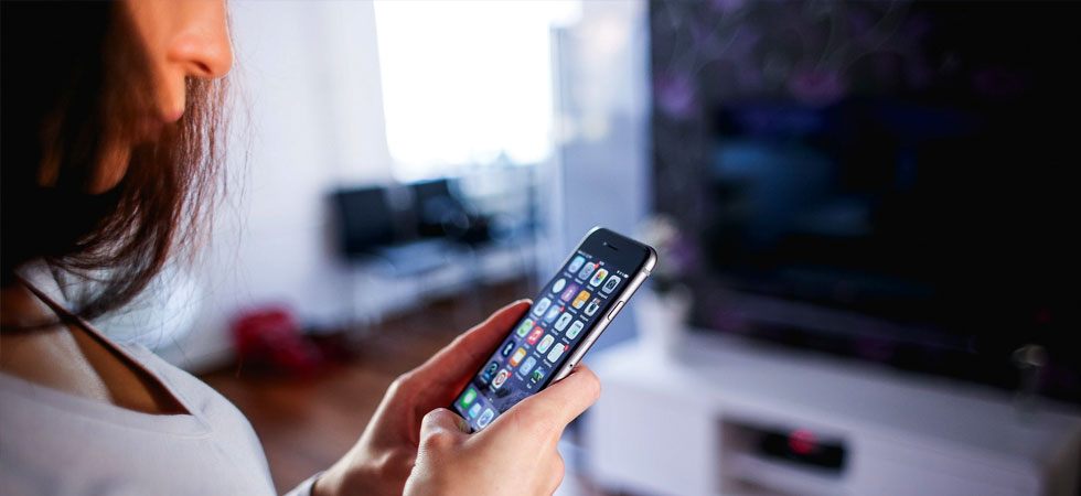 Woman looking at her zoomed in smartphone